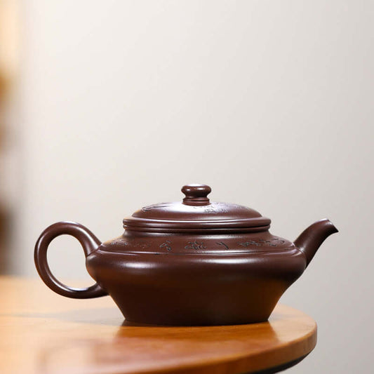 Handmade Yixing purple sand teapot on wooden table, showcasing elegant craftsmanship and traditional design.