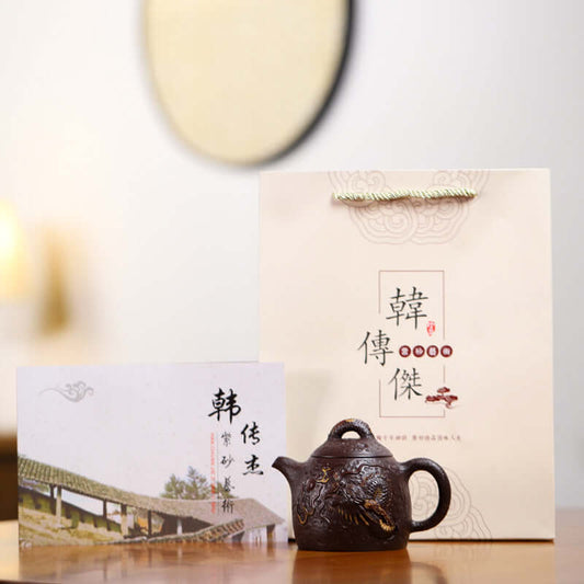 Handmade Yixing purple sand teapot with gift box and card, featuring traditional dragon relief craft.