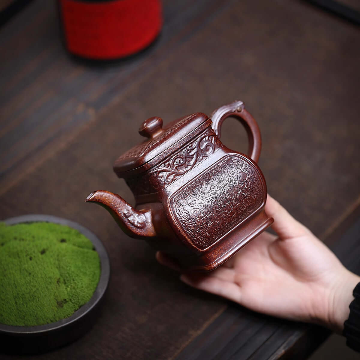 Handmade Yixing purple sand teapot with intricate design, showcasing traditional craftsmanship and ideal for household tea sets.