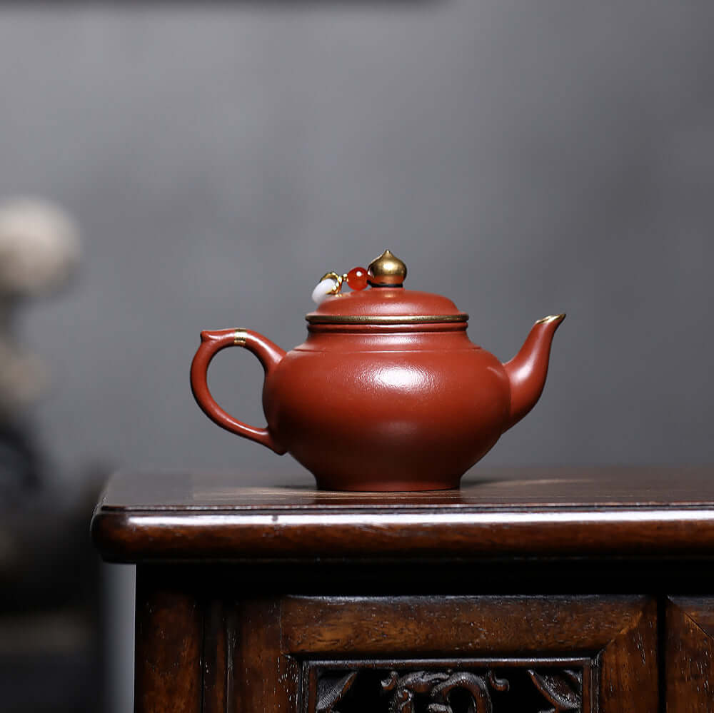 Handmade Yixing purple sand teapot with gold inlay and cherry blossom design, perfect for Kung Fu tea sets.