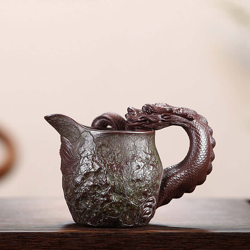 Handmade Yixing purple sand fair cup featuring a dragon-shaped handle, showcasing traditional craftsmanship.