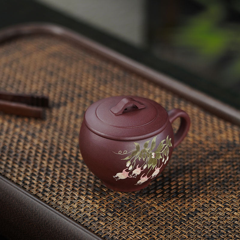 Handmade Yixing purple sand teapot with floral design, showcasing original craftsmanship and artistry in tea brewing.