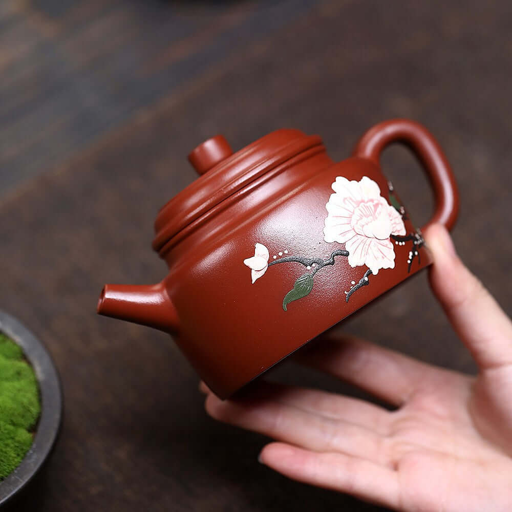 Handmade Yixing purple sand teapot with floral design, perfect for Kung Fu tea sets and tea enthusiasts.