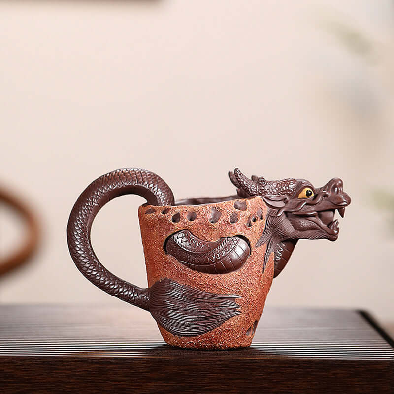 Handmade Yixing purple sand fair cup featuring a dragon design, ideal for tea enthusiasts and collectors.