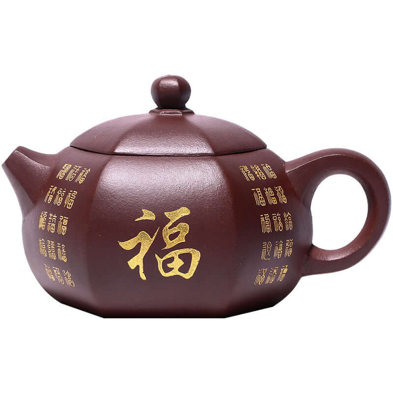 Handmade Yixing purple sand teapot with gold fu character carvings, traditional craftsmanship, and unique hexagonal design.