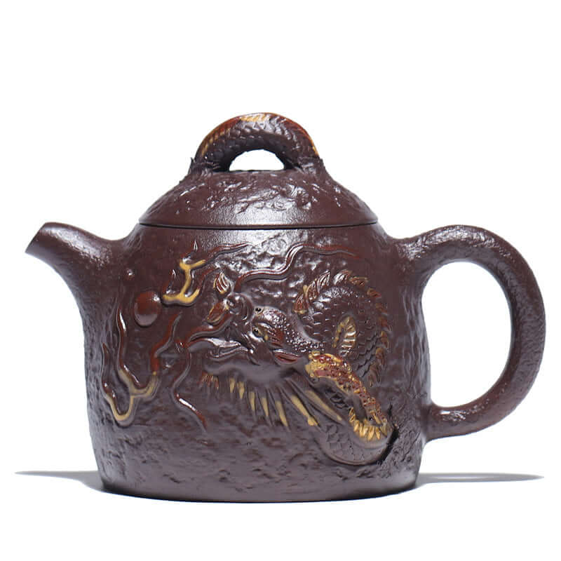 Handmade Yixing purple sand teapot with traditional dragon relief design, perfect for tea enthusiasts.