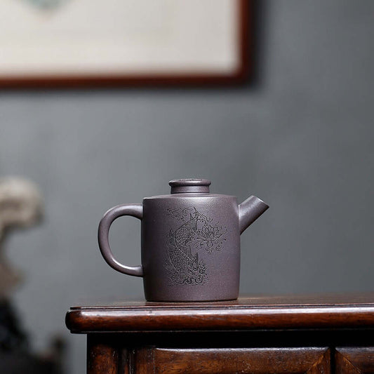 Handmade Yixing purple sand teapot featuring intricate design, perfect for Kung Fu tea set, made by skilled Yixing craftsman.