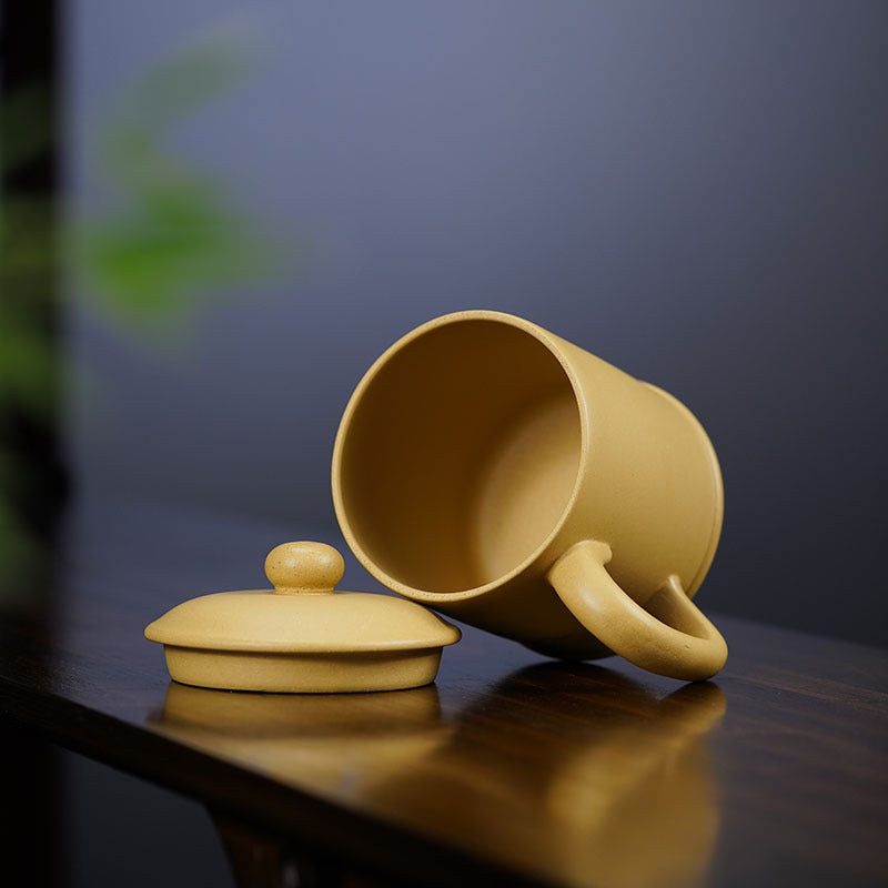Handmade Yixing purple sand cup with lid, showcasing original craftsmanship and unique design for tea enthusiasts.