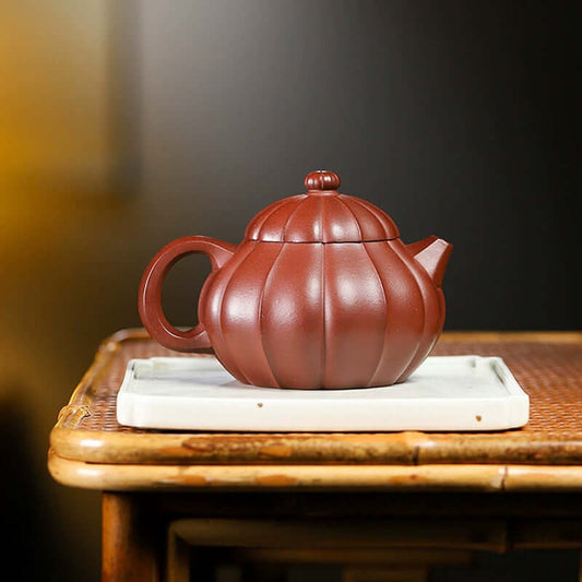 Handmade Yixing purple sand teapot with a unique ribbed design, perfect for home tea ceremonies.