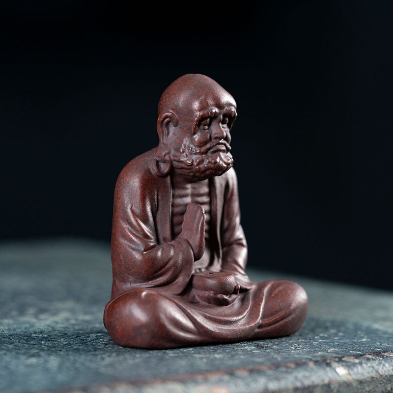 Handmade Yixing purple sand tea pet sculpture, depicting a wise character in a meditative pose, perfect for tea accessories.