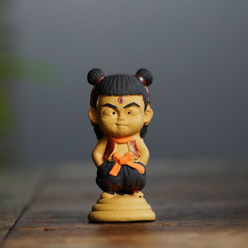 Handmade Yixing purple sand tea pet ornament featuring Nezha character, ideal for tea enthusiasts and creative displays.