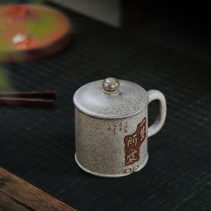 Handmade Yixing purple sand tea mug with lid, featuring traditional craftsmanship and unique design, perfect for tea lovers.