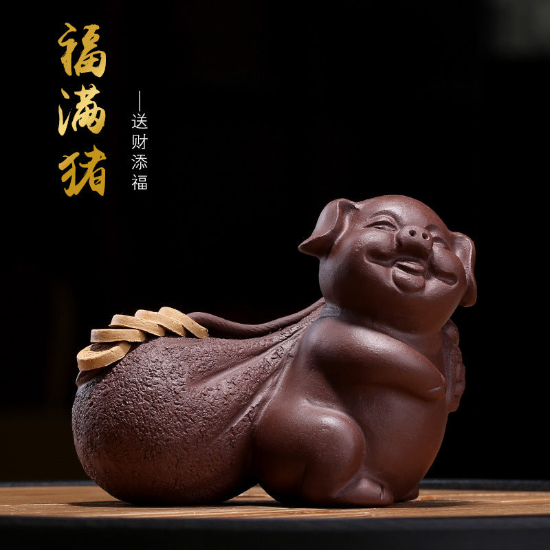 Handmade Yixing purple sand fortune pig figurine for tea tray decoration, symbolizing prosperity and good luck.