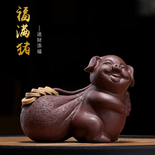 Handmade Yixing purple sand fortune pig figurine for tea tray decoration, symbolizing prosperity and good luck.