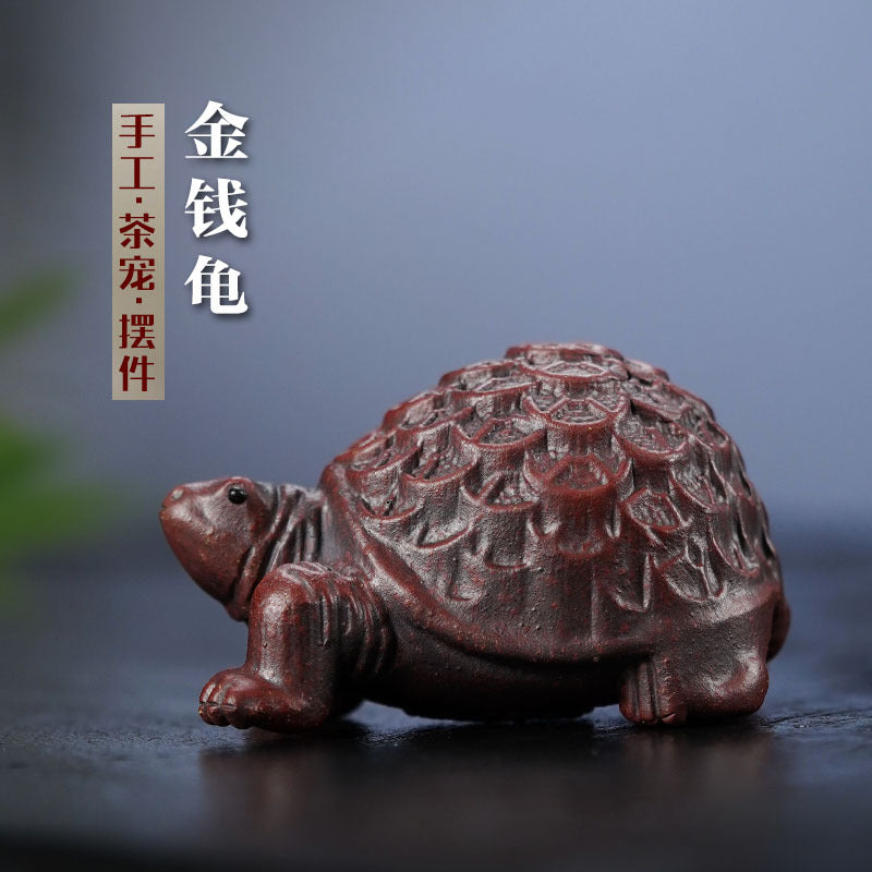 Handmade Yixing purple sand turtle ornament, crafted tea pet for home or office decoration, unique longevity design.