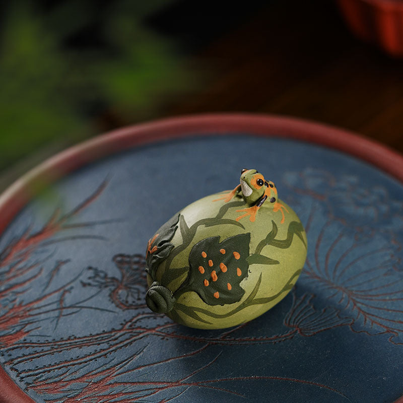 Handmade Yixing purple sand frog tea pet ornament, featuring intricate design on a decorative plate.