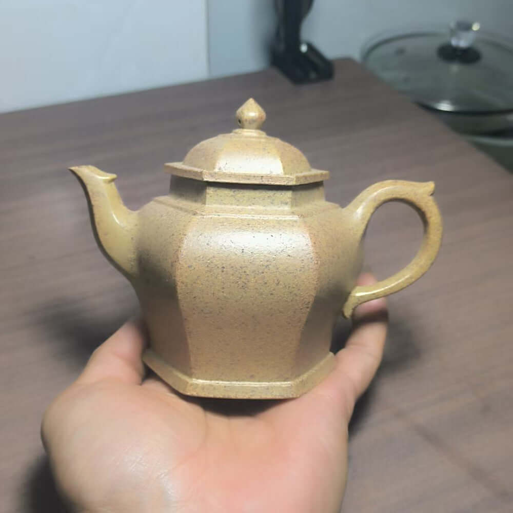 Handmade Yixing purple sand teapot, original materials, crafted by Yixing artisans, displaying unique hexagonal design.
