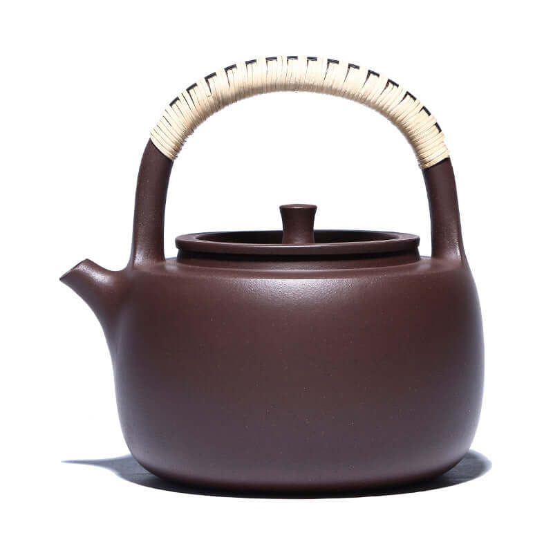 Handmade Yixing purple sand teapot with woven handle, perfect for brewing tea and high resistance to heat.