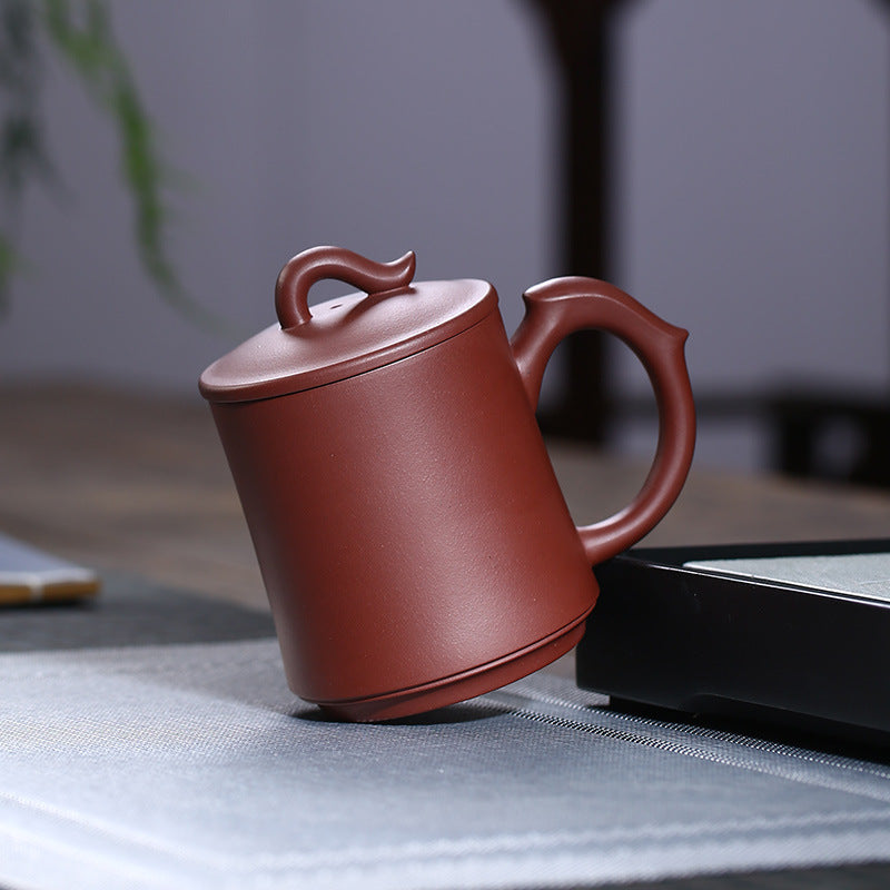 Handmade Yixing purple sand cup with unique handle design, perfect for office use and tea enthusiasts.