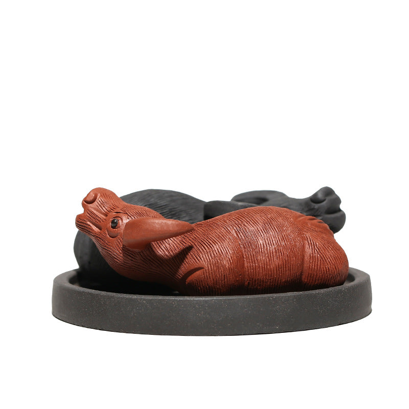 Handmade Yixing purple sand tea pet ornament, featuring two playful figures, ideal for tea lovers and collectors.