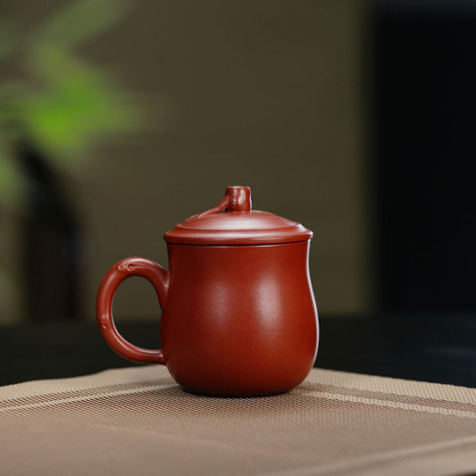 Handmade Yixing purple sand cup with lid, showcasing traditional craftsmanship for tea enthusiasts.