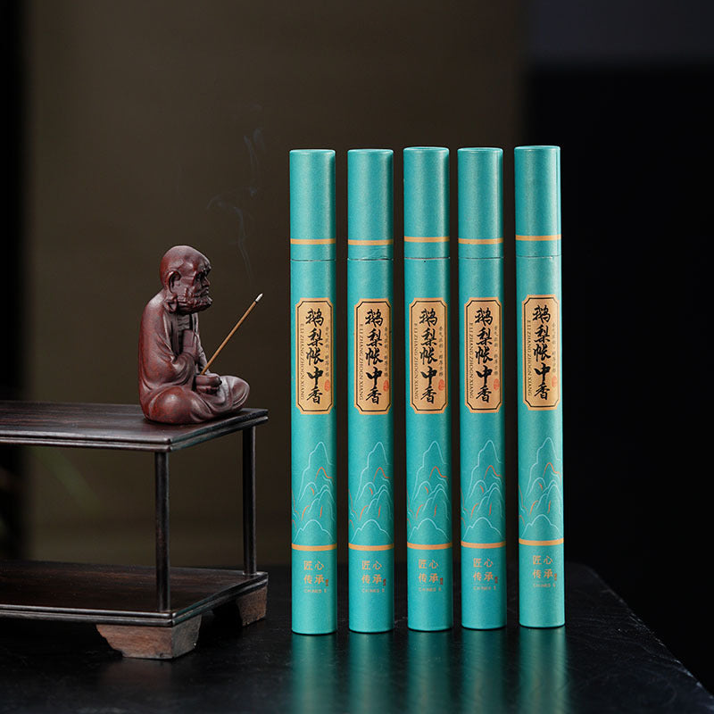 Handmade Yixing purple sand tea pet ornament with incense, set on a traditional wooden tea table.
