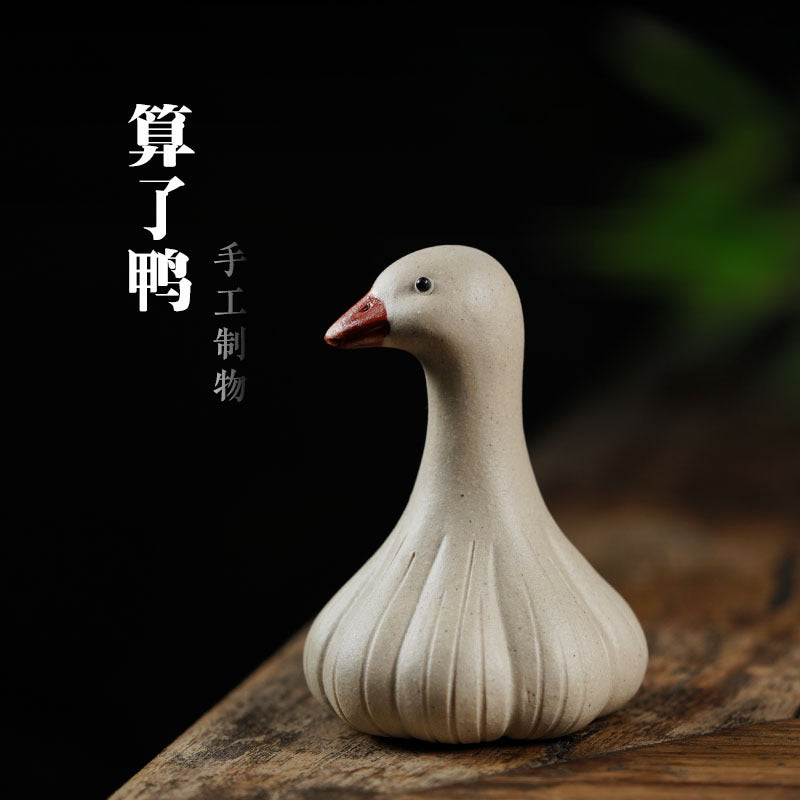 Handmade Yixing purple sand tea pet ornament, cute goose design, ideal for tea ceremonies and decoration.