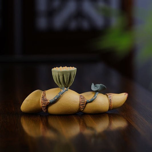 Handmade Yixing purple sand tea pet decoration, featuring a lotus root design for tea play and display.