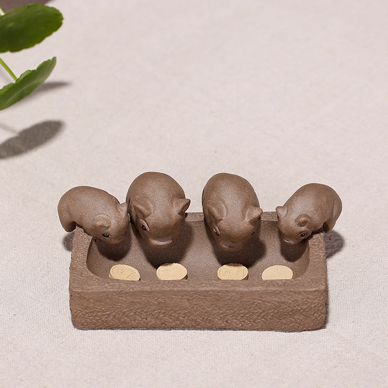 Handmade Yixing purple sand piglet tea pet figurines for tea ceremony, features four cute pigs and coins.