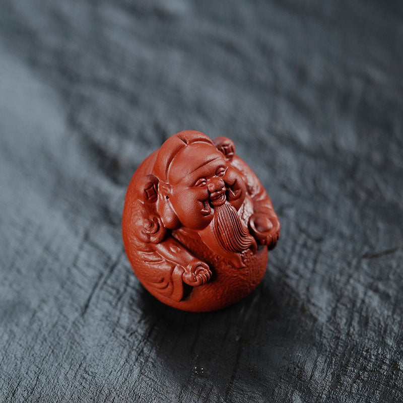 Handmade Yixing purple sand tea pet sculpture of the God of Wealth, perfect for tea table accessories.