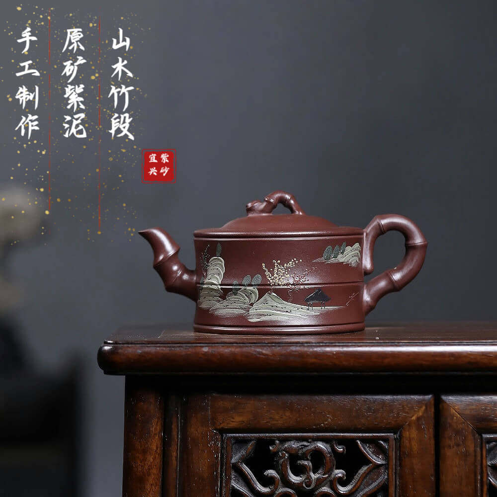 Handmade Yixing purple sand teapot with landscape design, crafted for kung fu tea sets, showcasing traditional artistry.