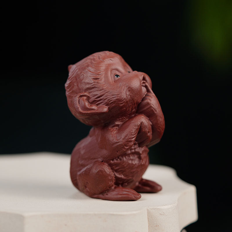 Handmade Yixing purple sand tea pet sculpture of a happy monkey, perfect for tea table ornaments.