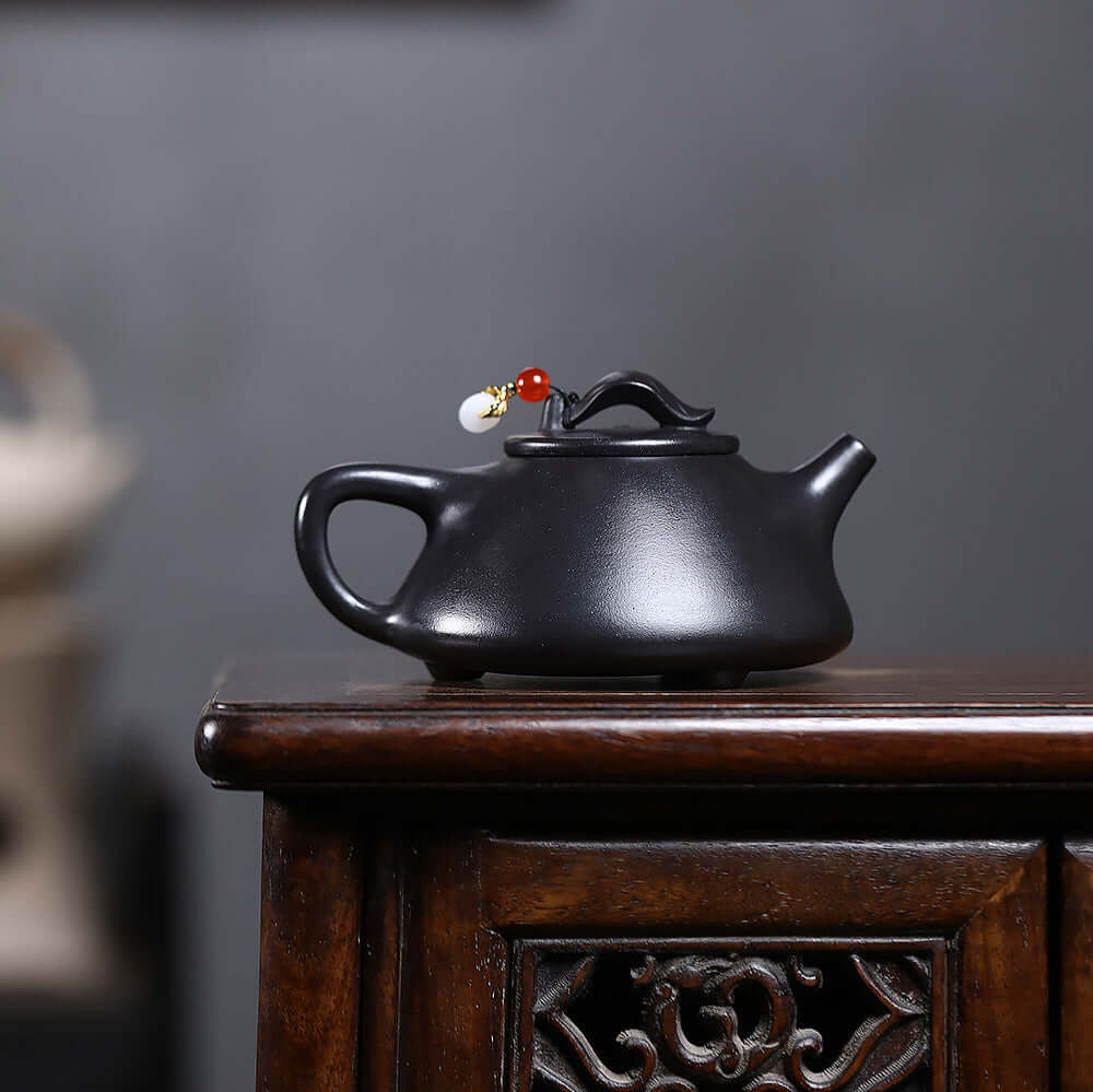 Handmade Yixing purple sand teapot with unique design, perfect for home Kung Fu tea set and tea enthusiasts.
