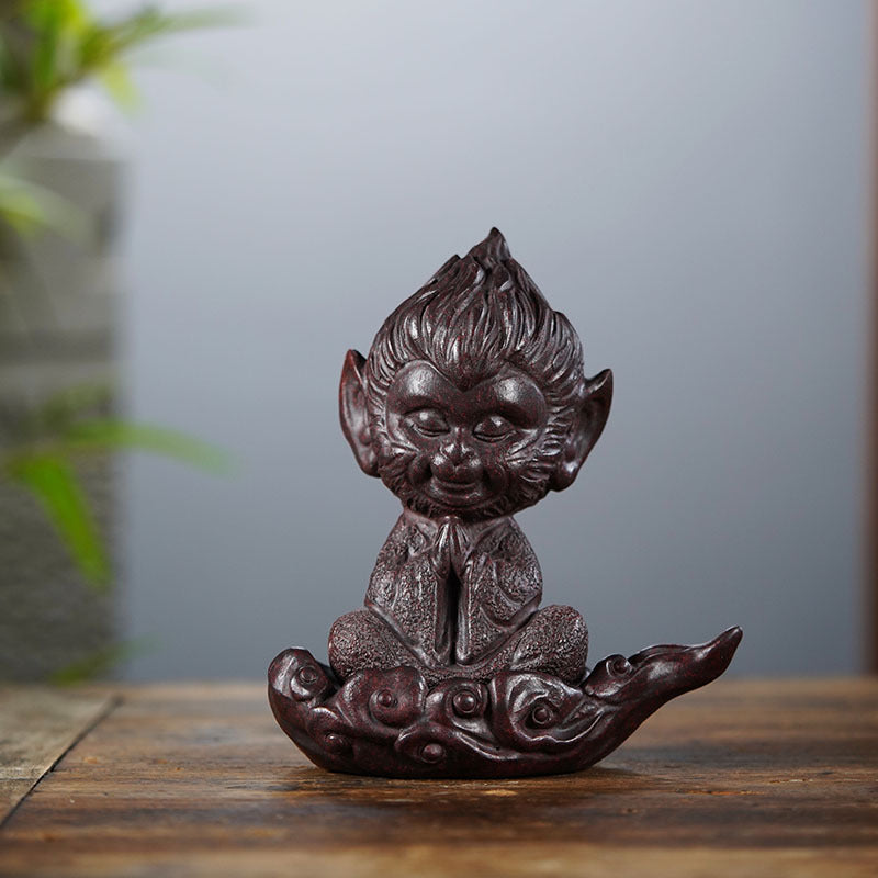 Handmade Chinese-style purple sand Sun Wukong ornament, featuring a joyful monkey sitting on an auspicious cloud.