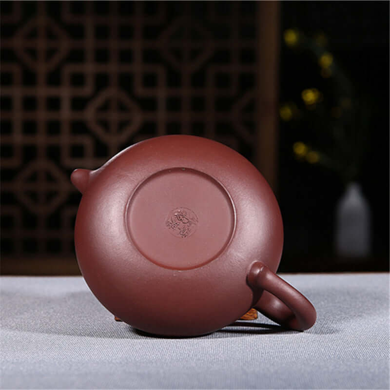 Handmade Yixing purple sand teapot base showcasing fine craftsmanship and natural clay texture.