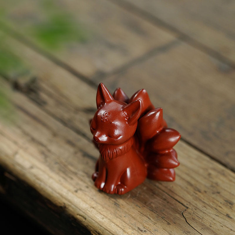 Handmade Yixing purple sand nine-tailed fox tea pet sculpture, perfect for tea table accessories and creative tea toys.