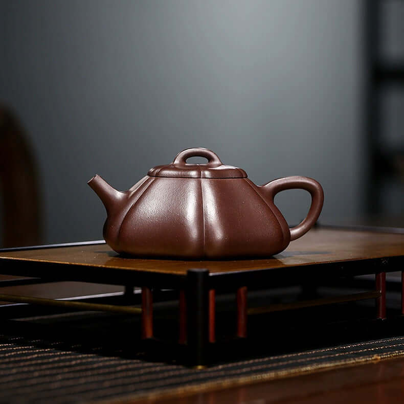 Handmade Yixing purple sand teapot with a unique design, crafted from original purple clay, perfect for elegant tea brewing.