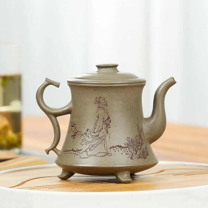 Handmade Yixing purple sand teapot with intricate art, featuring a curved handle and elegant design.