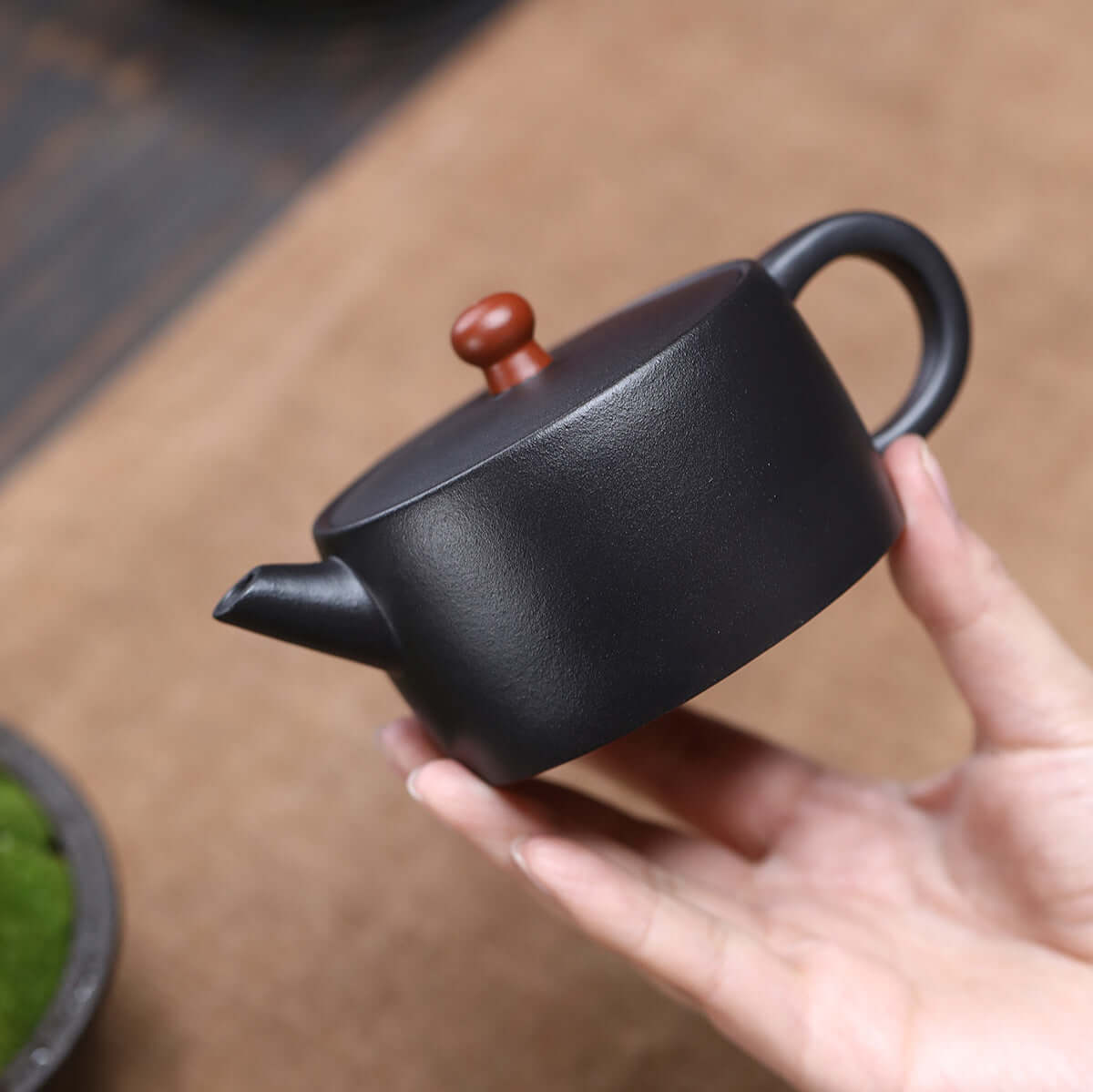 Handmade Yixing purple sand teapot, showcasing smooth design and earthy tones, perfect for Kung Fu tea ceremonies.