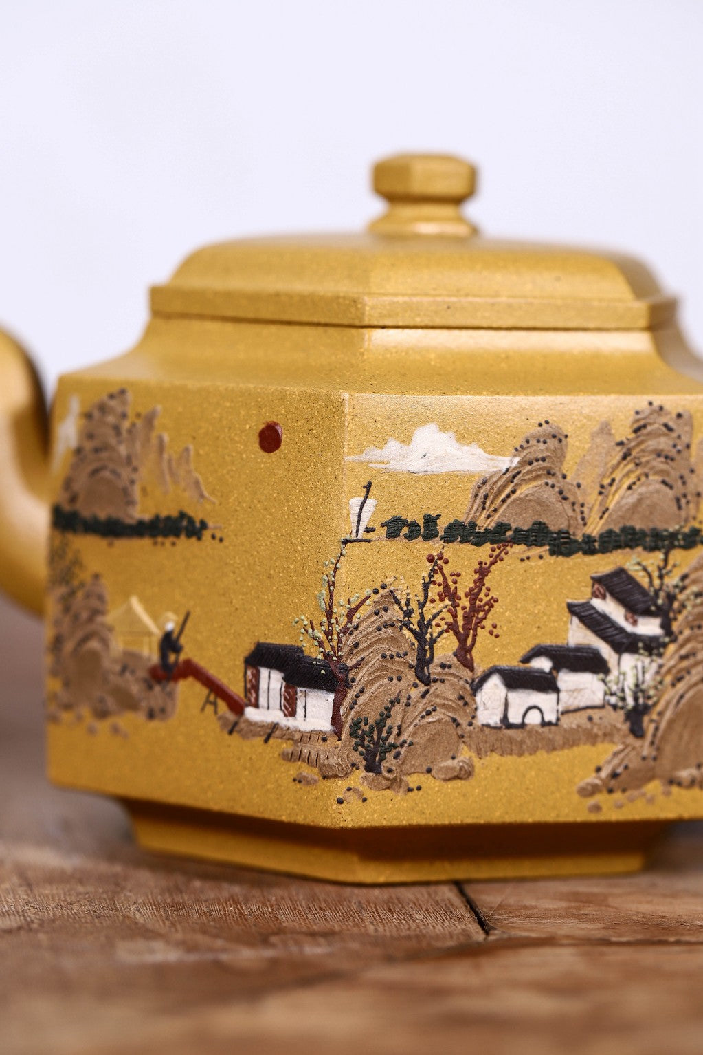 Handmade Yixing purple sand teapot featuring intricate landscape painting and classic hexagonal design, 300CC capacity.