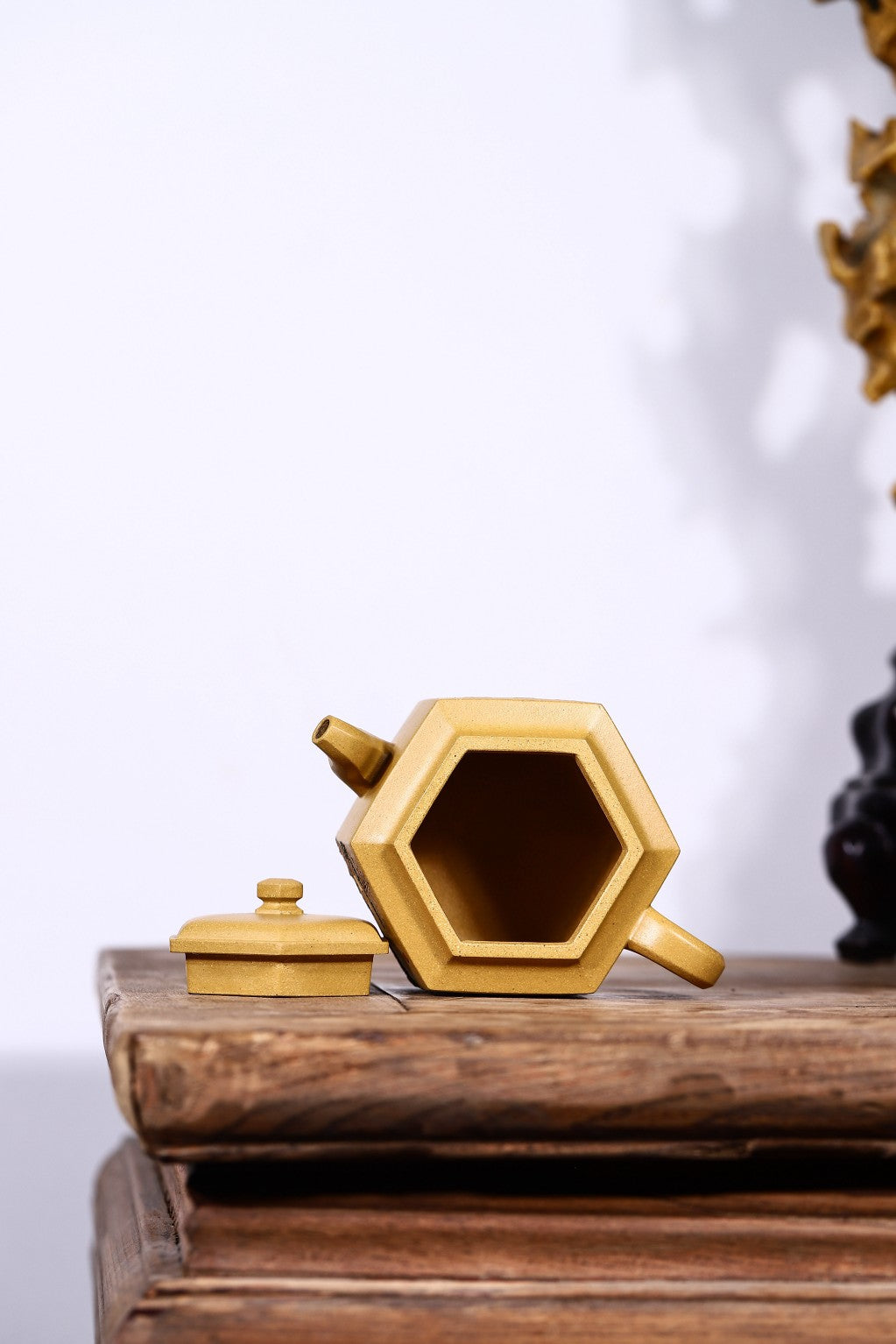 Handmade hexagonal Yixing purple sand teapot with lid, showcasing unique design and craftsmanship.