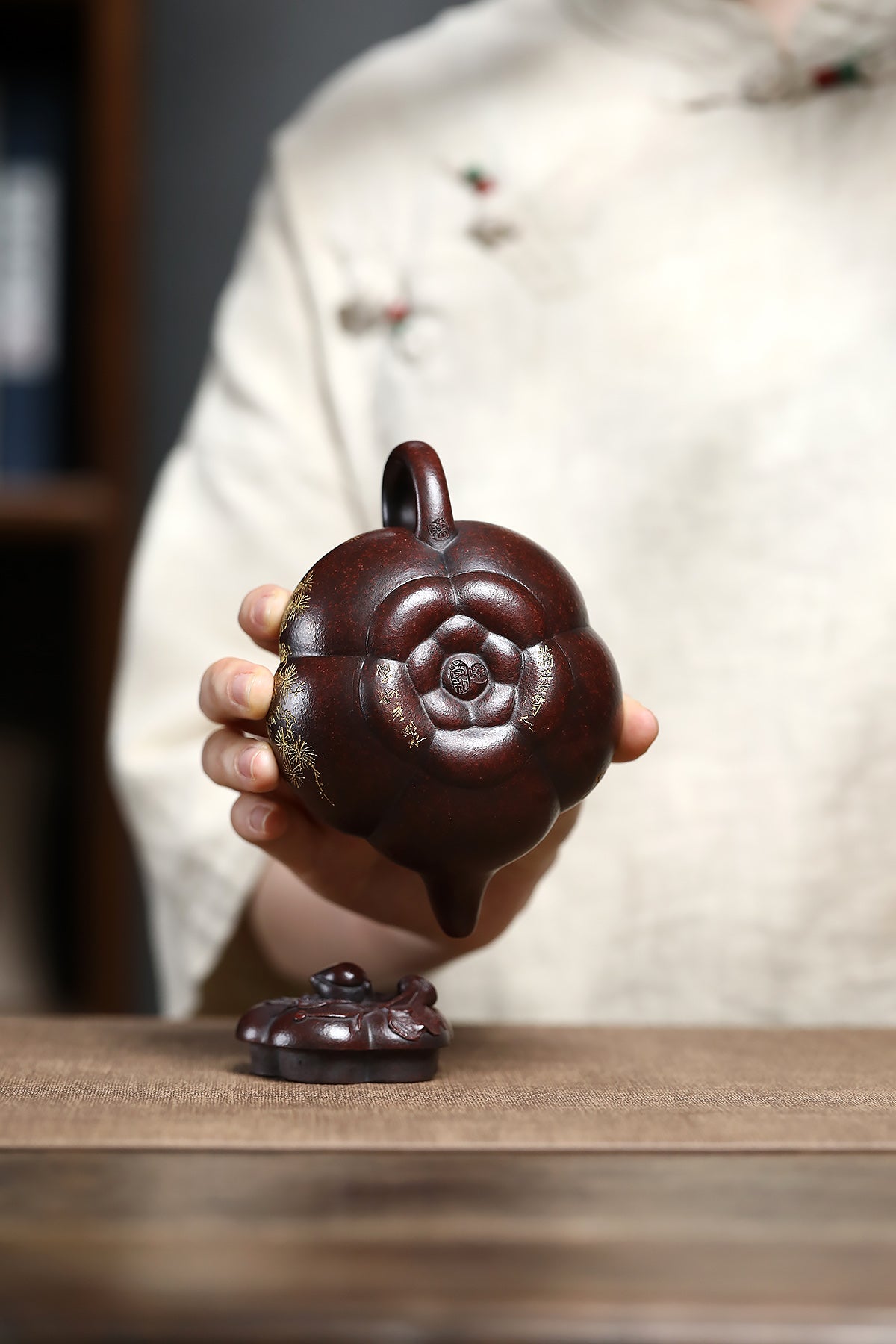 Handmade Yixing purple sand teapot shaped like a double peach, showcasing intricate details and craftsmanship.