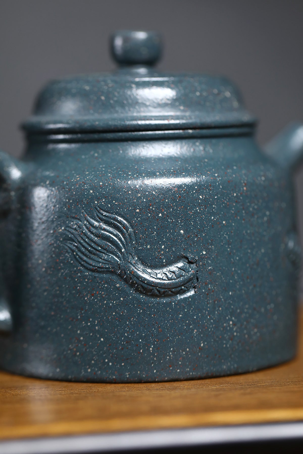Handmade Yixing purple sand teapot with intricate dragon design and unique speckled glaze, showcasing traditional craftsmanship.