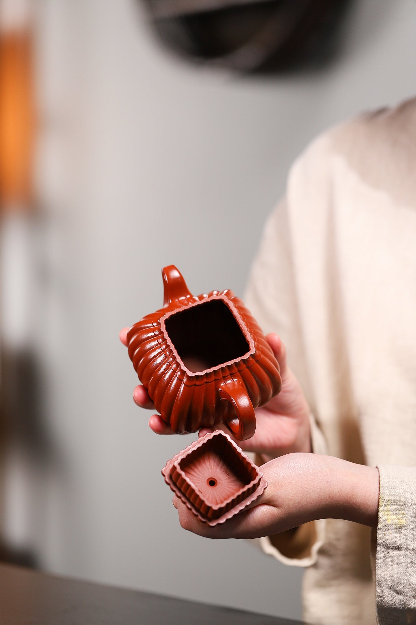 Handmade Yixing purple sand teapot showcasing a square design with intricate details, perfect for tea enthusiasts.