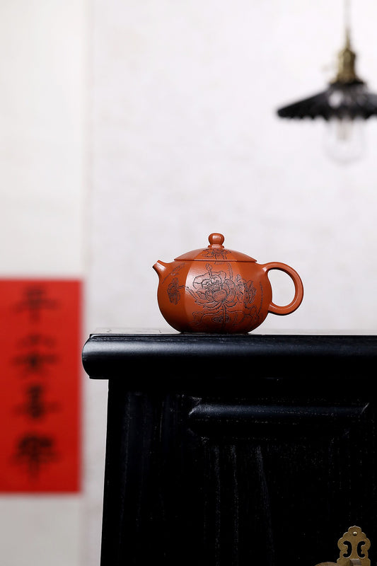 Handmade Yixing purple sand teapot, elegantly displayed on a black surface with artistic background, showcasing intricate design.