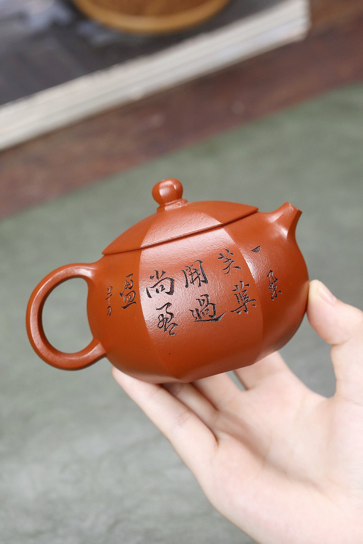 Handmade Yixing purple sand teapot with intricate calligraphy, showcasing fine craftsmanship and artistic beauty.