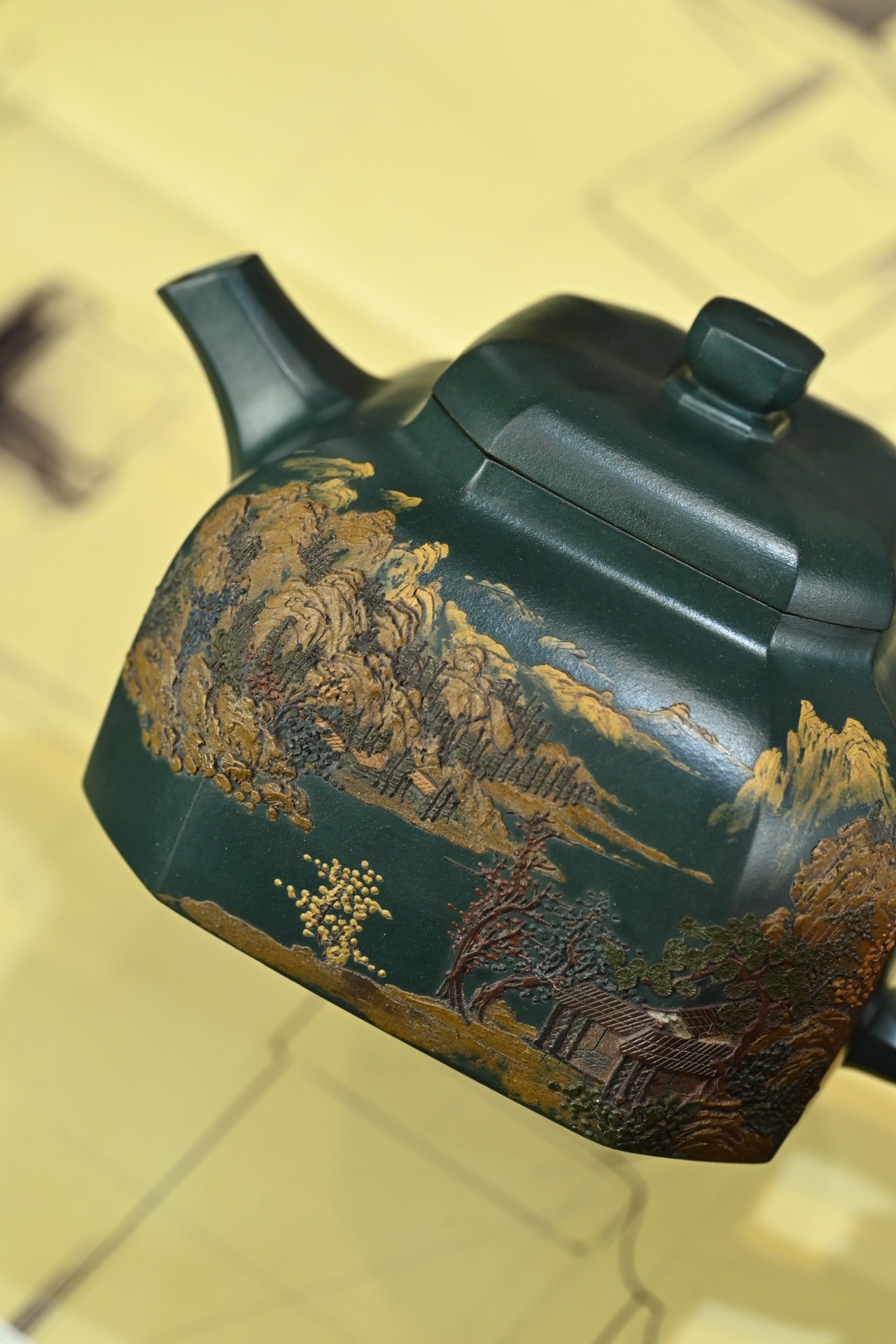 Handmade Yixing purple sand teapot showcasing intricate landscape design and traditional craftsmanship.