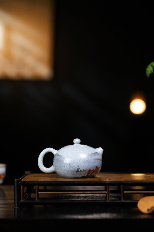 Handmade Yixing purple sand teapot on a wooden tea tray, showcasing traditional craftsmanship and elegant design.