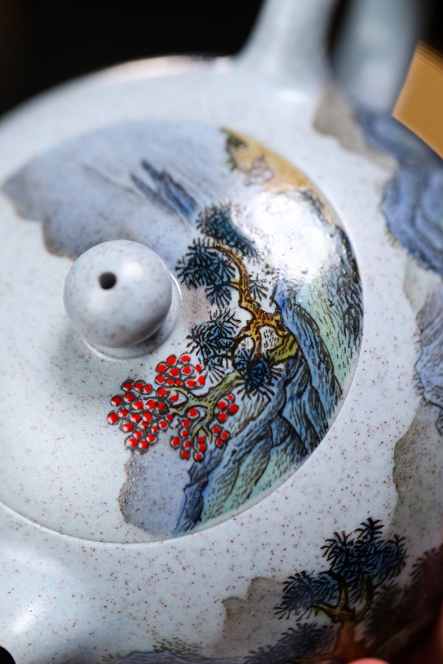 Handmade Yixing purple sand teapot featuring intricate landscape painting and colorful botanical details.