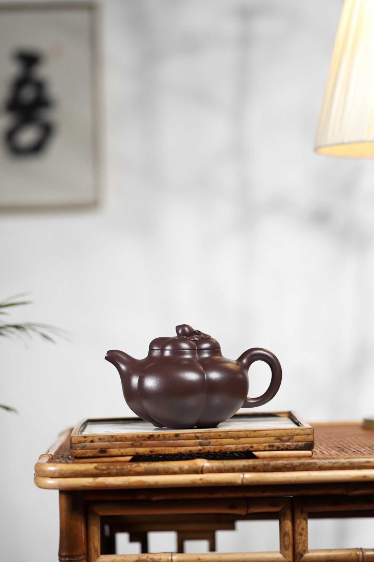 Handmade Yixing purple sand teapot in a traditional setting, showcasing elegant curves and craftsmanship.